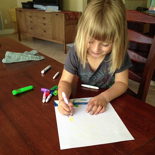 Emily drawing Rachel and Mark's new house on Hawaii