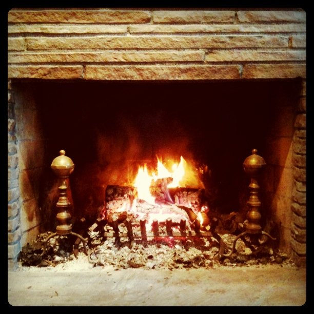 Is enjoying a lovely fire in Orinda on a drizzly day.
